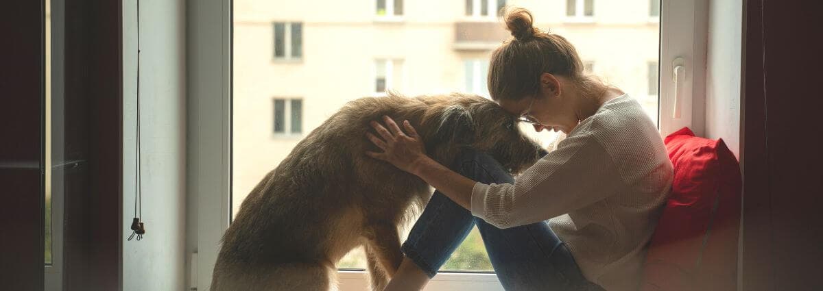 Sad woman with emotional support dog