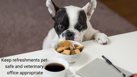 Photo of a dog with paws up on a counter, trying to reach chocolate cookies